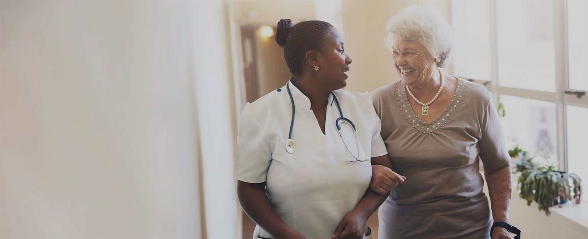 resident-walking-with-nurse-in-corridor.jpg