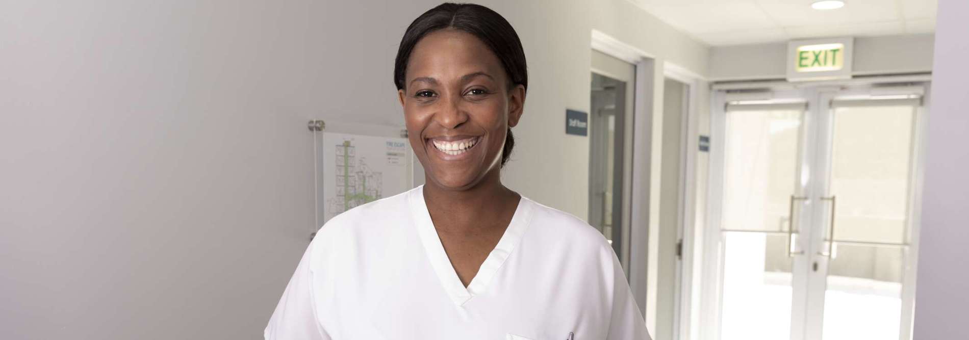 smiling nurse in corridor (1)