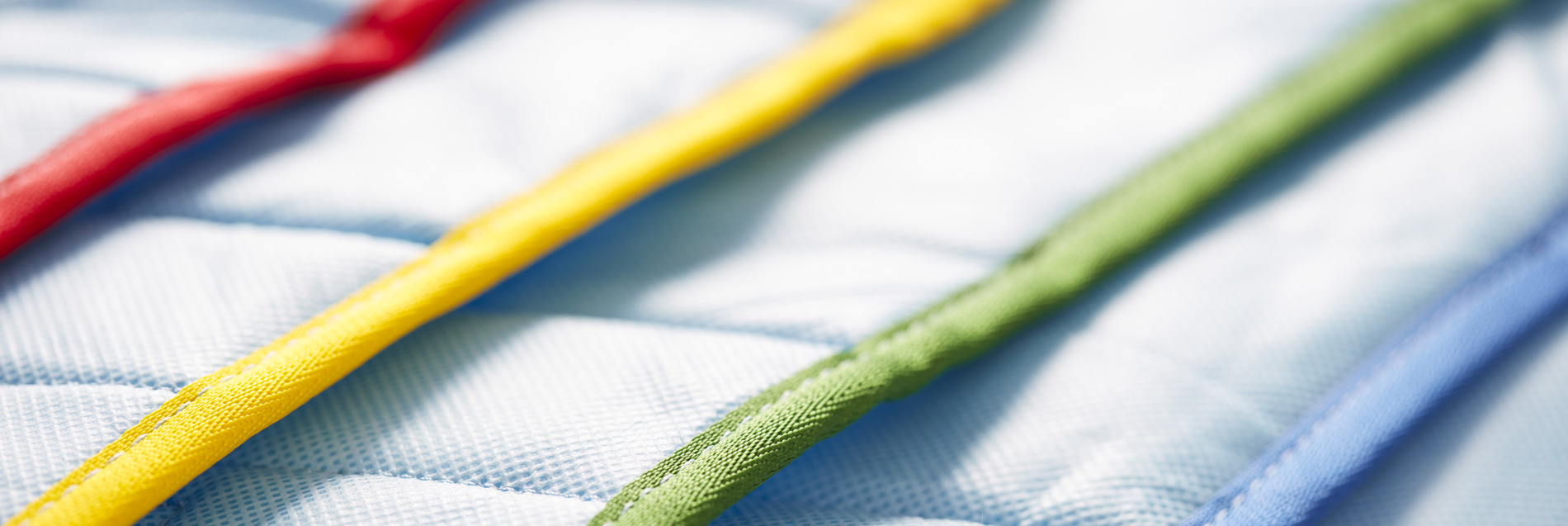 High-resolution product photo of a disposable loop sling used in patient handling, shown in a clean clinical setting.