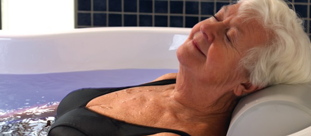 Arjo-Products-Hygiene-Systems-Bathing-Central-Bathing-Area-Rhapsody-Bath-Sound-and-Vision-Female-Patient-Wellness_570x250.jpg