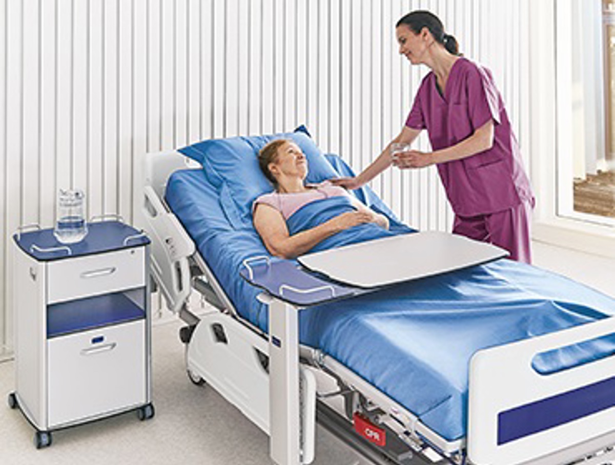 arjo-solutions-medical beds-bedside furniture-nurse and patient in bed_370x280.jpg